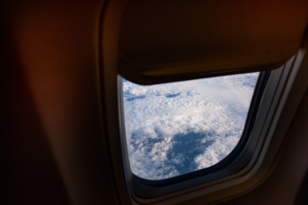 Airplane window from inside. Through the window you can look at the ground.