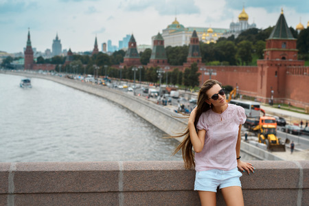 Beautiful hipster girl on the Moscow city background. Russia, Moscow, Red Square, Moskva river - 2016.の写真素材