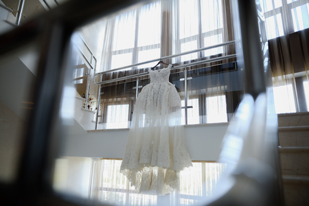 Wedding white bride dress on the background of a large window.の写真素材