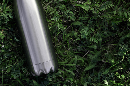 Stainless  water bottle, isolated on grass backgroundの写真素材