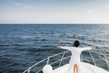 Caucasian couple standing on bow of yacht in sea.の写真素材