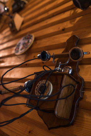 Old home phone on wooden wall backgroundの写真素材