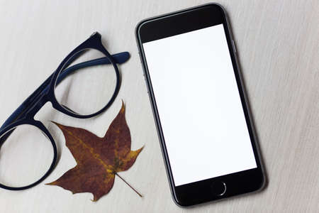 Autumn concept and smartphone with mockup screenの写真素材