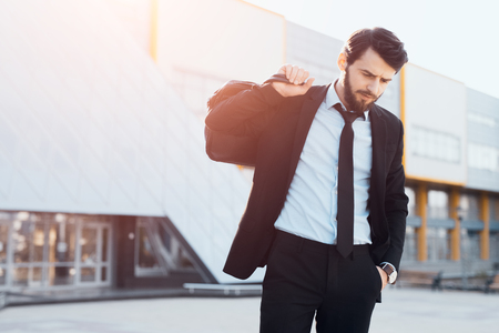 Hipster bearded businessman with black bag outdoorの写真素材