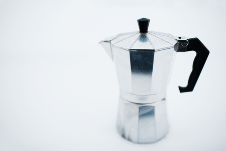 Coffee moka pot over white background on snow.の写真素材