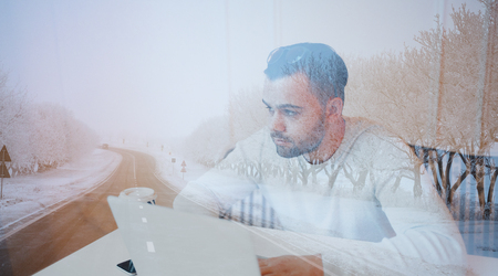 Double exposure of young pensive businessman and one road.