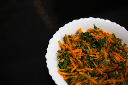 Salad in white plate on black background.の写真素材