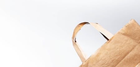 Close-up of eco paper bag isolated on white background.