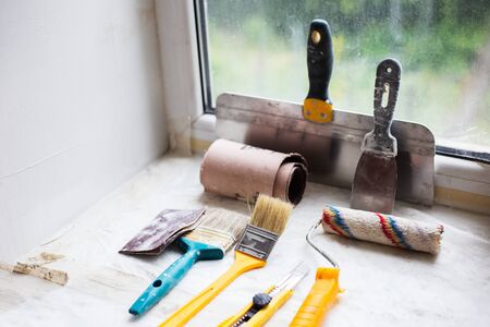 Close-up of putty knife, paint roller, brush and other supplies.の写真素材