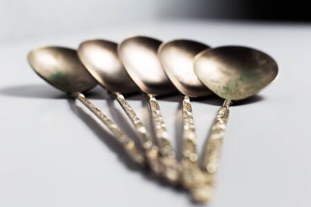 Collection of ancient spoons. On background of white.の写真素材