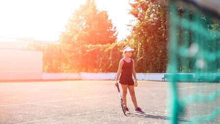 Portrait of teenage girl playing tennis on sport court.の写真素材
