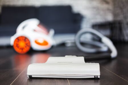 Close-up of vacuum cleaner on dark laminate.の写真素材