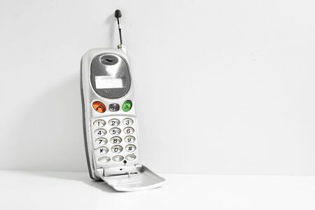 Old cell phone isolated on white background.の写真素材