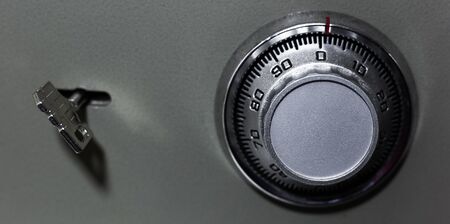 Close-up of security lock and key of safe.