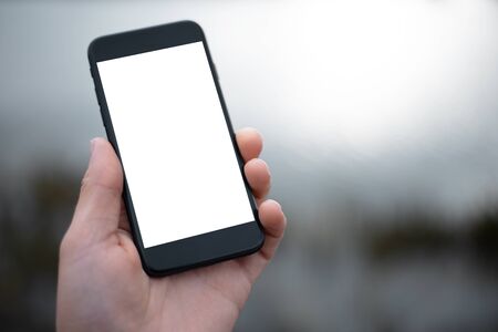 Close-up of smartphone with mockup in man hand.