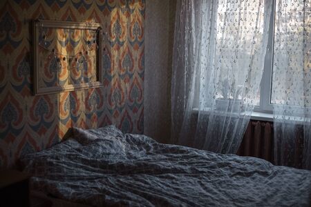 Cosy bedroom with sunlight shadows