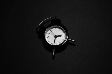 Top view of clock on black background.の写真素材