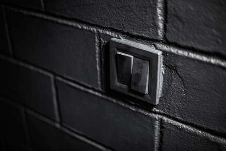 Portrait of young man sitting on the sofa and using smartphone.の写真素材