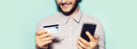 Panoramic portrait of young man wearing medical face mask on yellow background.の写真素材