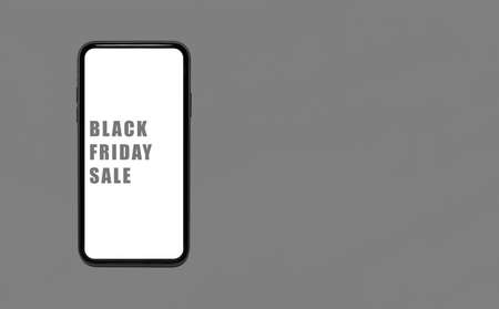 Black friday sale text on screen of smartphone in female hand. Background of black brick wall.の写真素材