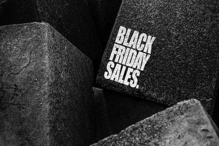 Black friday sales text, on the black and white stones background.の写真素材