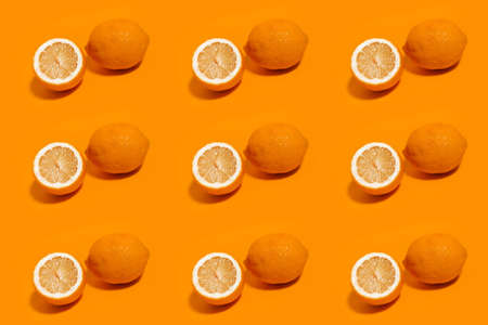 Colorful pattern of lemons isolated on background of orange color.