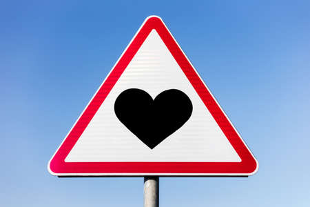Blank road sign on the background of blue sky.