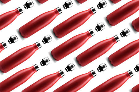 Bottle pattern. Set of eco colorful reusable steel thermo water bottles of red color, isolated on white background. Zero waste.の写真素材