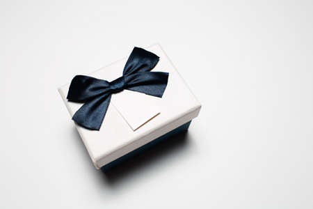 Close-up of small gift box with bow isolated on white background.