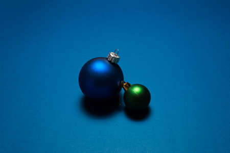 Close-up of two Christmas tree toys ornaments on background of blue color.の写真素材