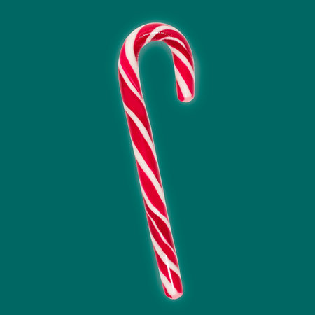 Studio photo of candy cane isolated on tidewater green background.の写真素材