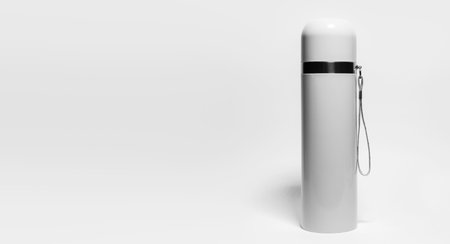 Close-up of grey steel stainless thermos isolated on white background with copy space. Black and white photo.の写真素材