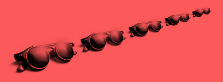 Panoramic photo of round sunglasses on red background.の写真素材