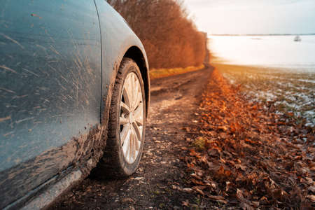 Close-up of muddy wheel of car on road. Offroad driving.