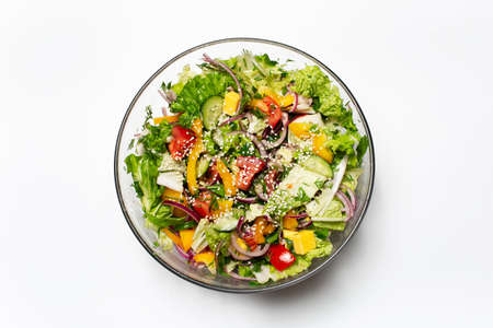 Top view of bowl with green salad on white background.の写真素材