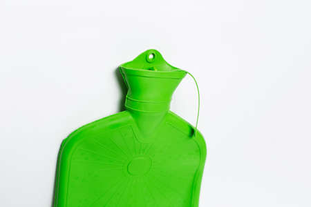 Close-up of green medical hot water bottle on white background.の写真素材
