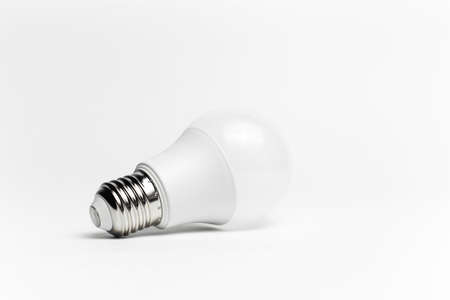 Close-up of eco light bulb isolated on white background. Minimalistic object concept.