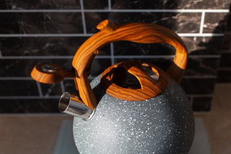 Top view close-up photo of metallic  kettle with wooden handle in kitchen.の写真素材