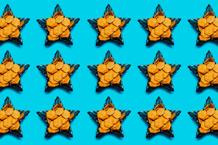 Pattern of spicy crackers in glass bowls in shape of star on blue background.