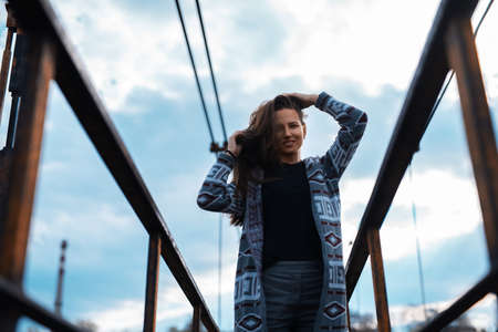Portrait of young girl standing on abandoned old bridge with perspective background.の写真素材