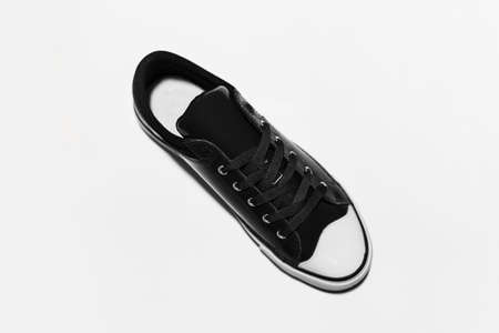 Top view of black vintage sneaker shoe on white background.の写真素材