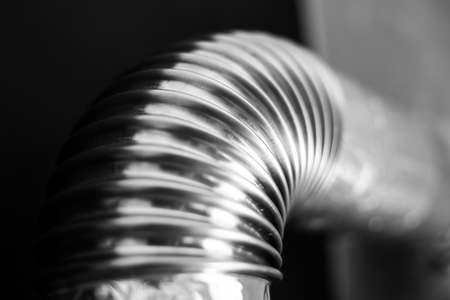 Close-up of steel pipe with round corner on black background. Black and white photo.の写真素材