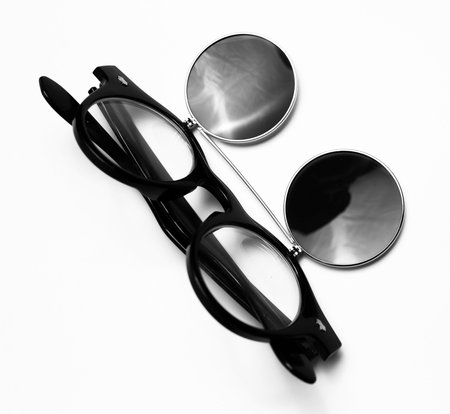 Close-up of round sunglasses of black color, isolated on white background.