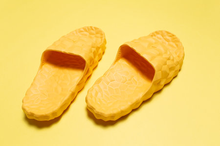 Yellow slippers on yellow background. Close-up view.の写真素材