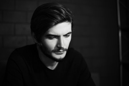 Black and white portrait of young thoughtful man.の写真素材