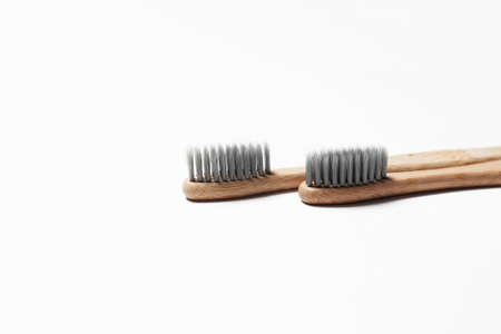 Close-up of two bamboo toothbrushes on white background.の写真素材