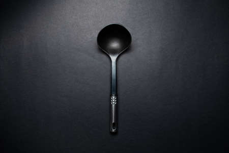 Studio picture of big black plastic dipper with chromed handle.の写真素材