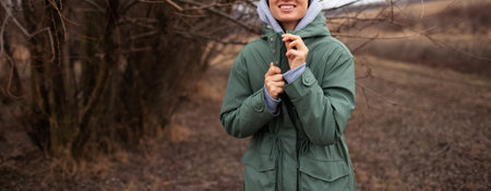 Panoramic portrait of smiling girl in green jacket with copy space.の写真素材