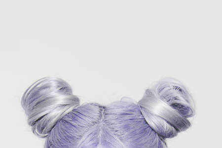 Close-up of two buns of very peri color. Hairstyle concept.の写真素材