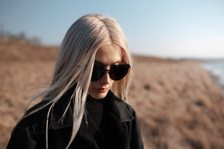 Outdoor portrait of cute blonde girl in the field. Wearing sunglasses.の写真素材